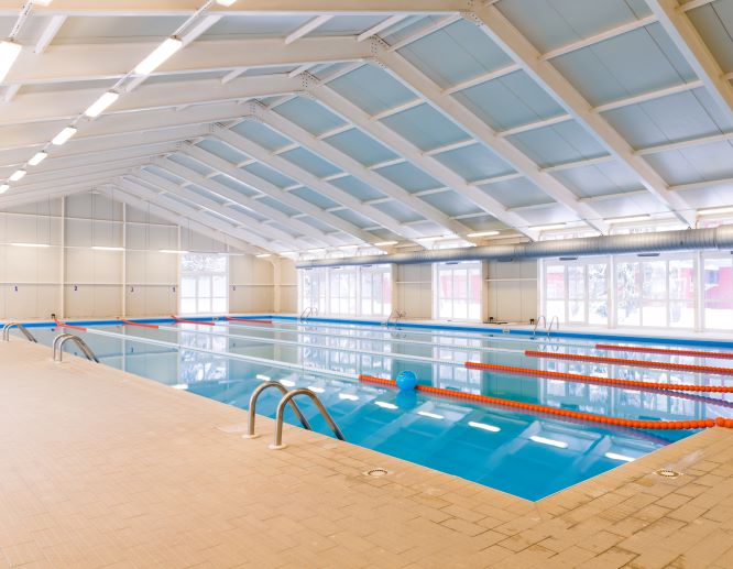 Colorful indoor recreation swimming pool at Midco Aquatic Center with family-friendly features