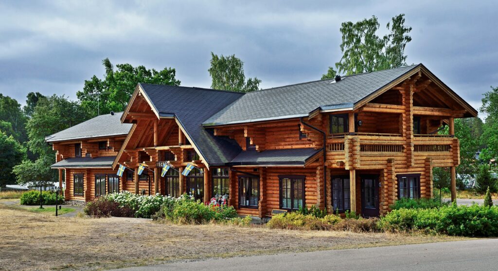 Different types of log homes including full scribe, milled, handcrafted, hybrid, and timber frame styles